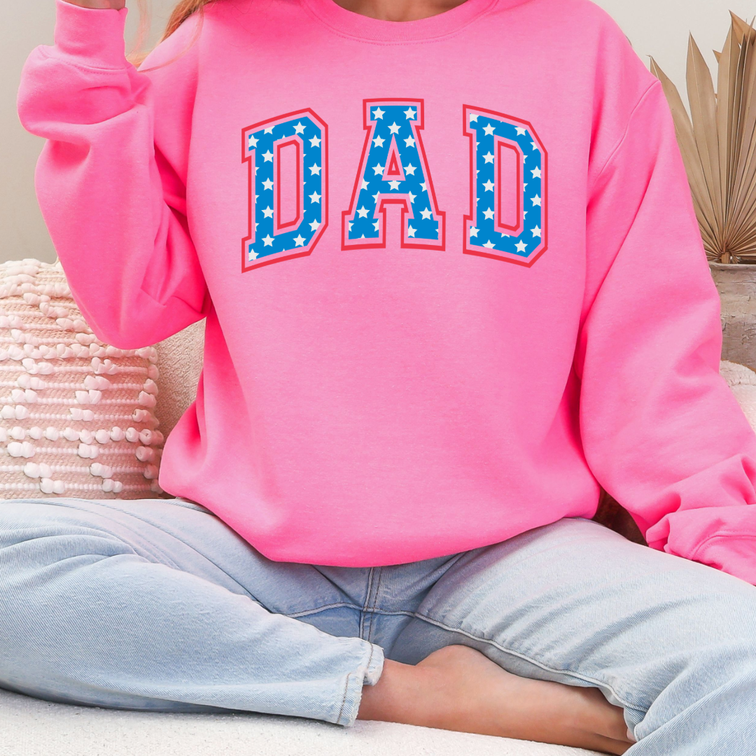 Customized adult Hot Pink Crewneck  with Seasonal 4th of July University style Font DAD blue with white stars outlined un red , This style is available in adult  Graphic Tees as well as adult crewnecks and hoodies .Available In DAD, MAMA and MINI. 