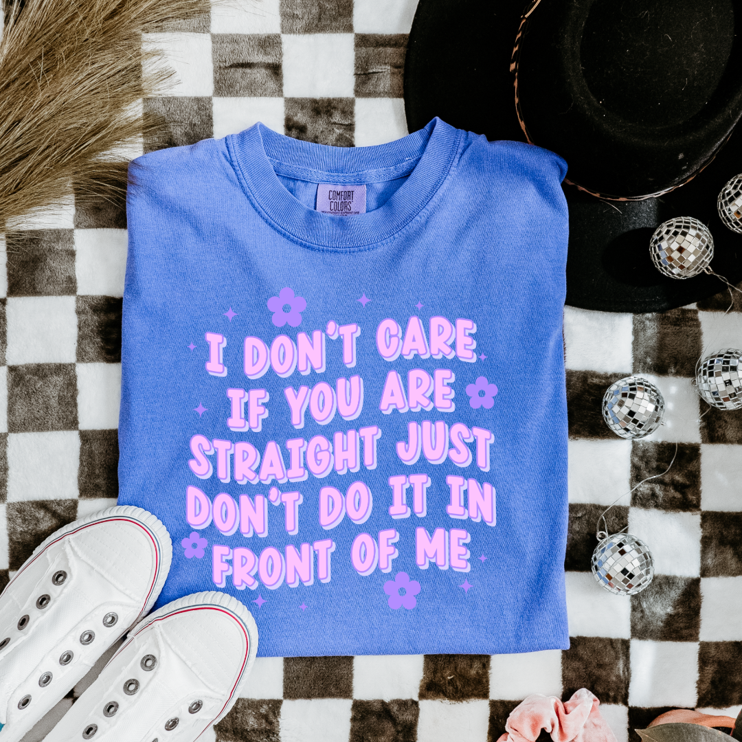 Customized Adult Comfort Colors Flo Blue Graphic Tee Quoted " I don't care if you're straight just don't do it in front of me.  Purple bubble letters with flowers spread out Matching Adult Crewnecks available Perfect for Pride.