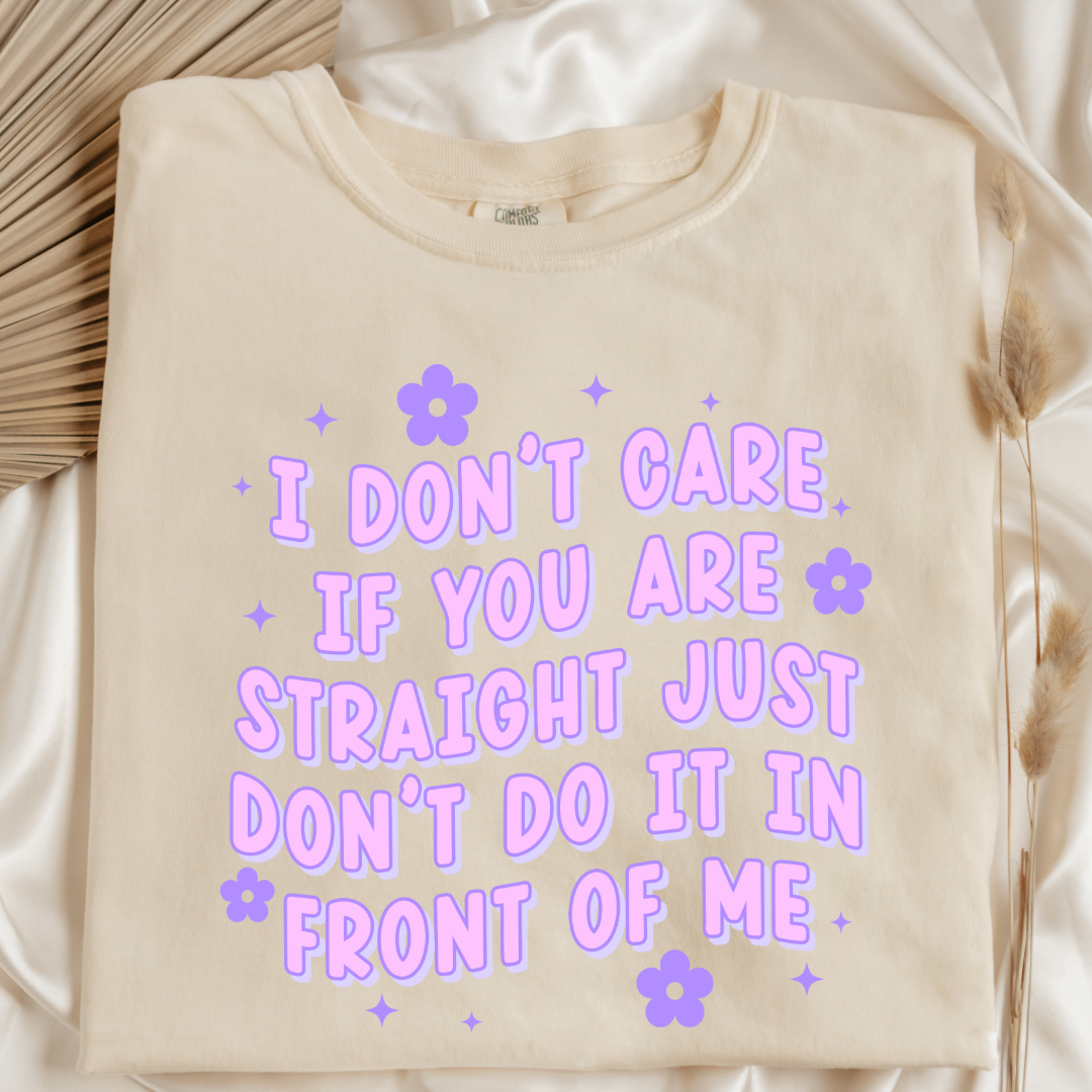 Customized Adult Comfort Colors Ivory folded flat lay Graphic Tee Quoted " I don't care if you're straight just don't do it in front of me.  Purple bubble letters with flowers spread out Matching Adult Crewnecks available Perfect for Pride.