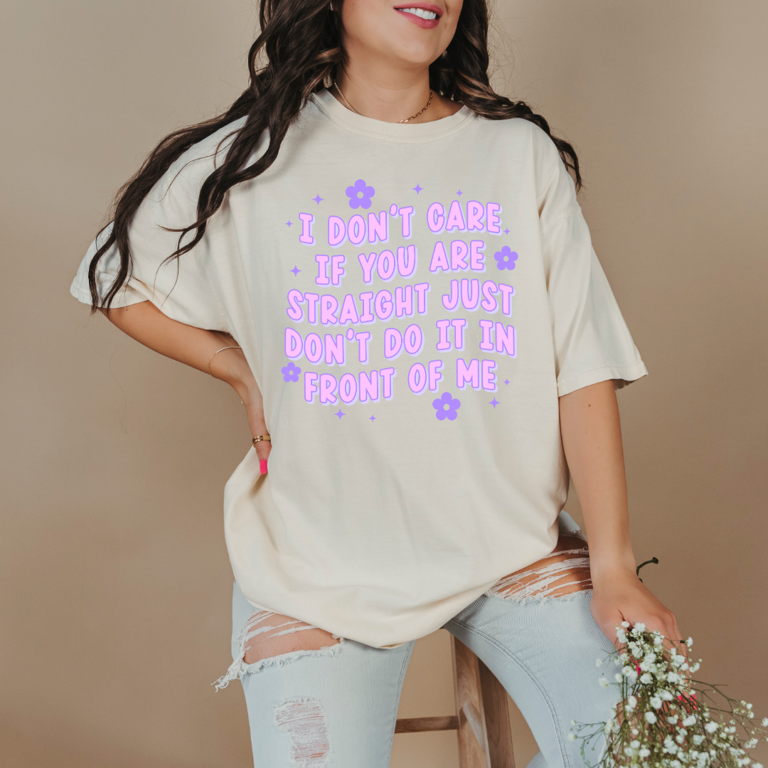 Customized Adult Comfort Colors Ivory Graphic Tee Quoted " I don't care if you're straight just don't do it in front of me.  Purple bubble letters with flowers spread out Matching Adult Crewnecks available Perfect for Pride.