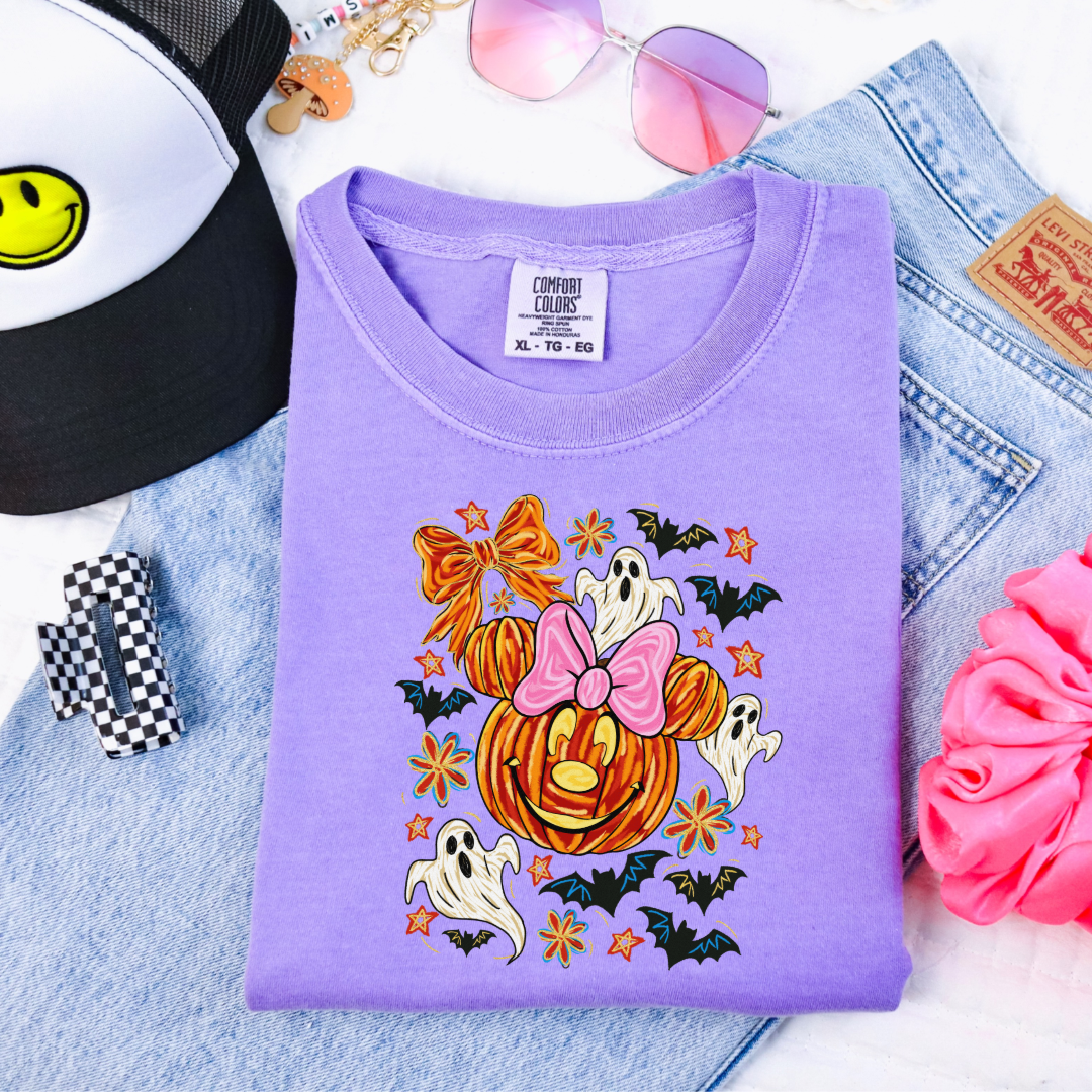 Youth Comfort Colors Violet Graphic Tee with Dimensional Minnie Mouse pumpkin head with ghosts, bows and bats. This Design Is available in Youth sizes Small through XL. Mickey Mouse available as well 
