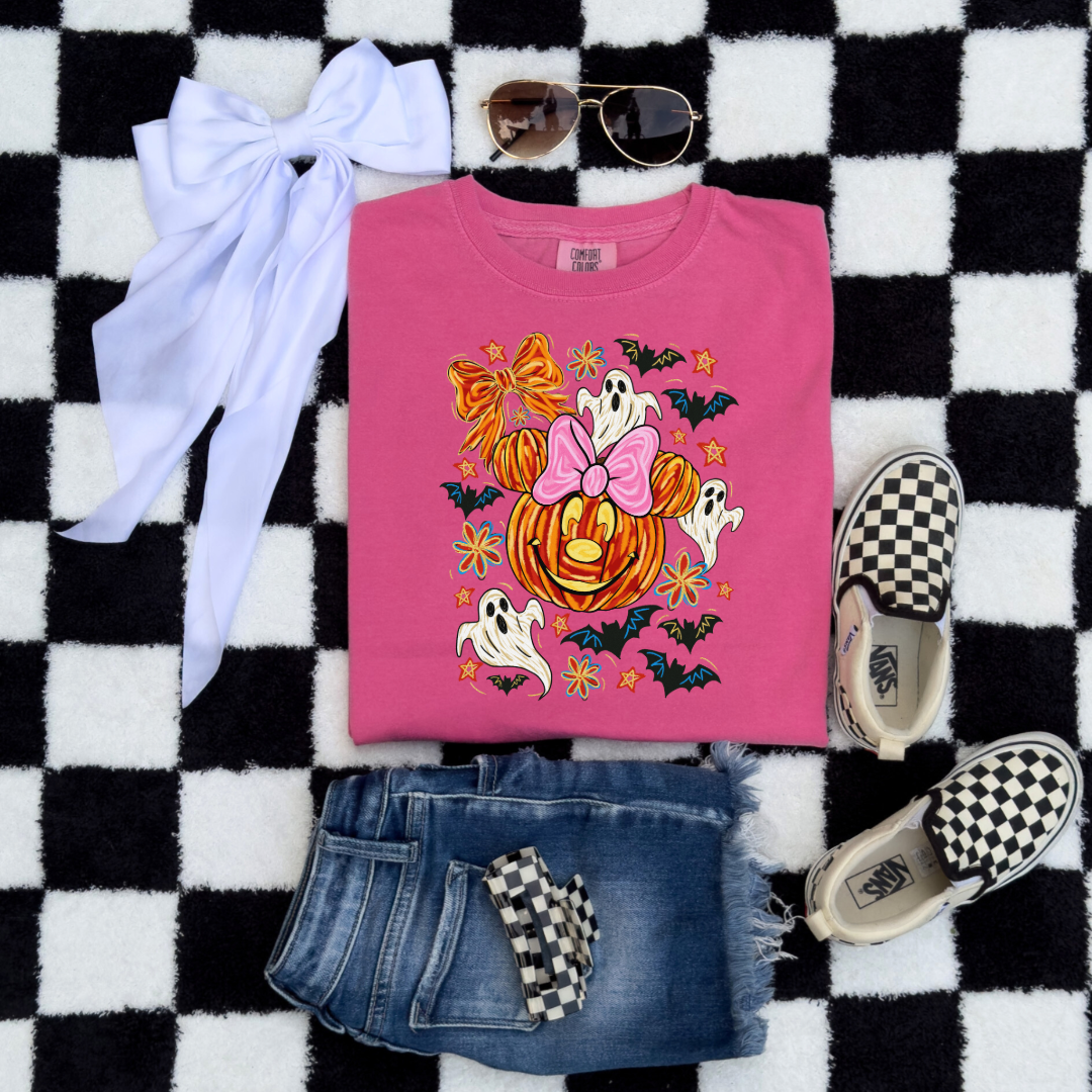 Youth Comfort Colors Crunchberry Pink Graphic Tee  with Dimensional Minnie Mouse pumpkin head with ghosts, bows and bats. This Design Is available in Youth sizes Small through XL. Mickey Mouse available as well 