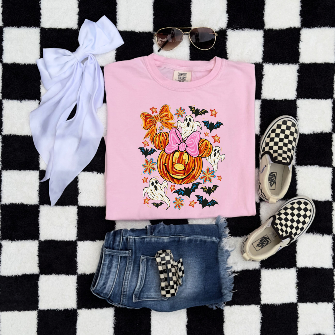 Youth Comfort Colors Blossom Pink folded flat lay Graphic Tee with Dimensional Minnie Mouse pumpkin head with ghosts, bows and bats. This Design Is available in Youth sizes Small through XL. Mickey Mouse available as well 