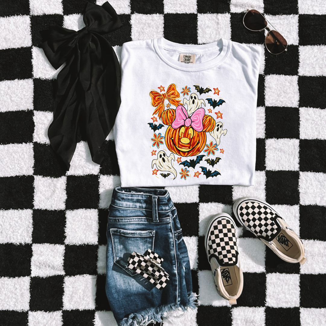 Youth Comfort Colors White Graphic Tee with Dimensional Minnie Mouse pumpkin head with ghosts, bows and bats. This Design Is available in Youth sizes Small through XL. Mickey Mouse available as well 