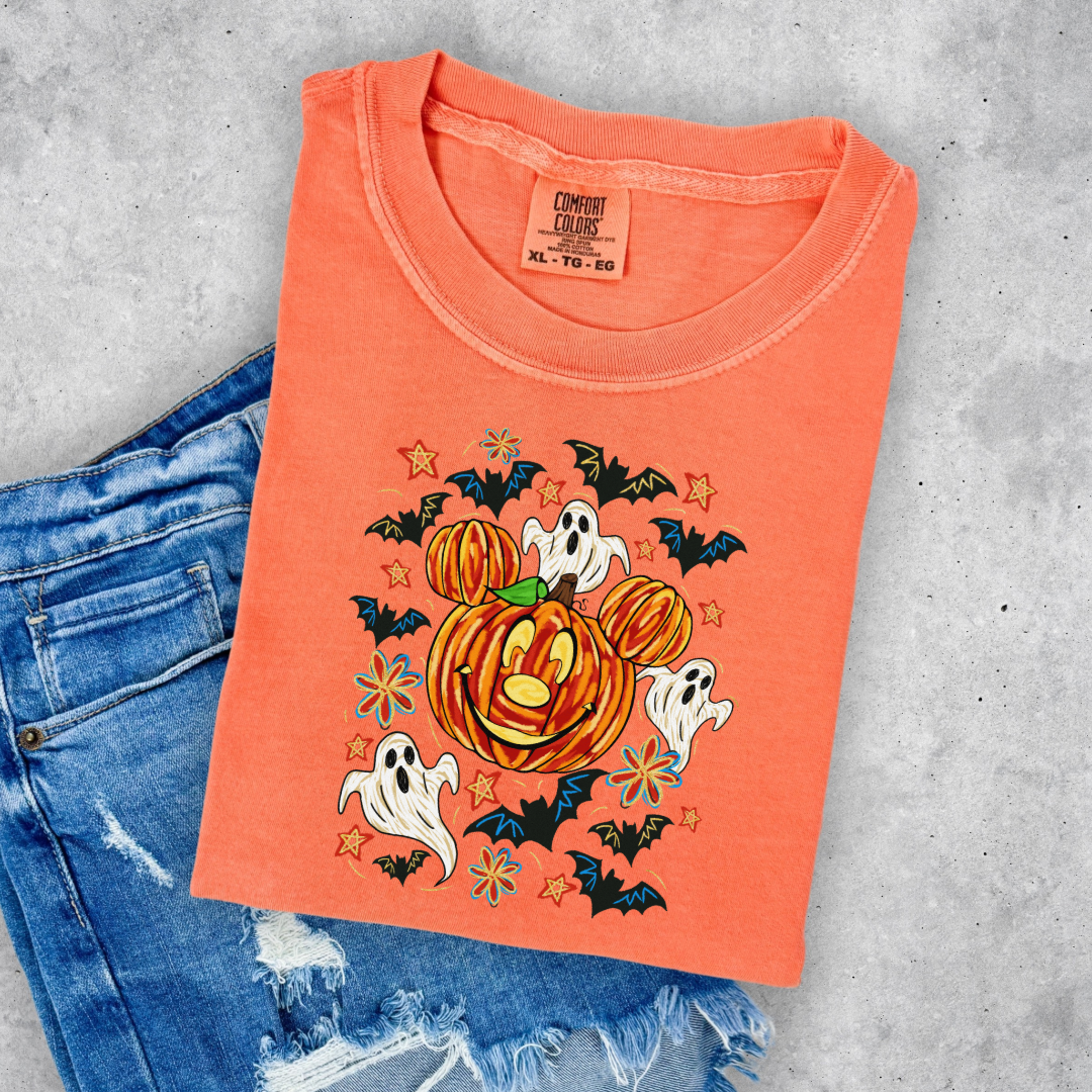 Youth Comfort Colors Melon Orange  Graphic Tee with Dimensional Mickey Mouse pumpkin head with ghosts, bows and bats. This Design Is available in Youth sizes Small through XL. Minnie Mouse available as well 