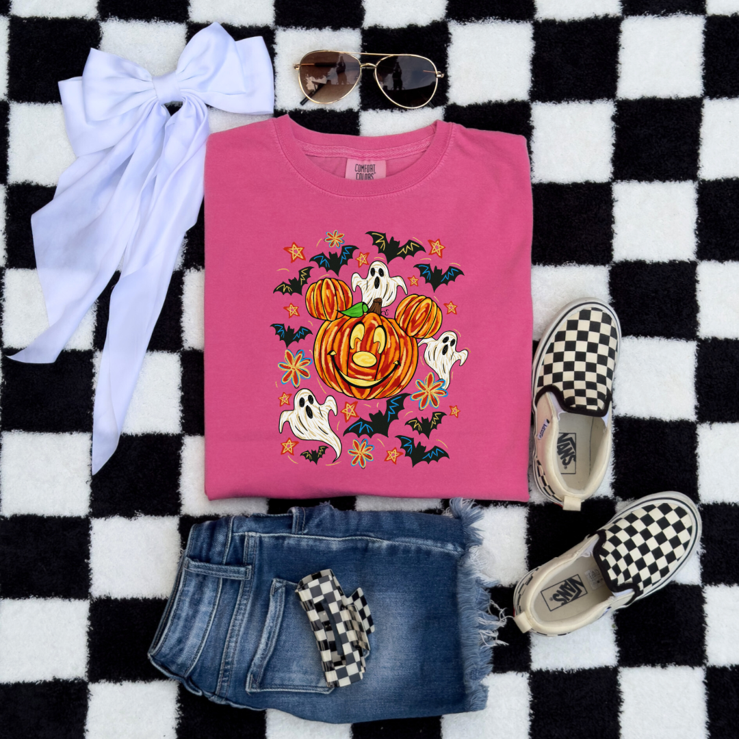 Youth Comfort Colors Crunchberry Pink Graphic Tee with Dimensional Mickey Mouse pumpkin head with ghosts, bows and bats. This Design Is available in Youth sizes Small through XL. Minnie Mouse available as well 