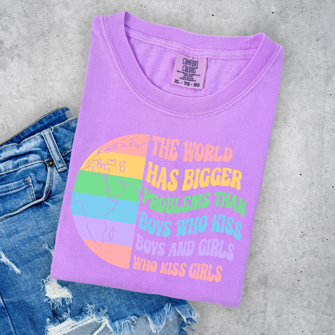 Customized Adult comfort colors Neon Violet Graphic tee. Split image rainbow world map on one side and quote " the world has bigger problems than boys who kiss boys. and girls who kiss girls" on the other matching adult crewnecks and hoodies available. Perfect for Pride month, 