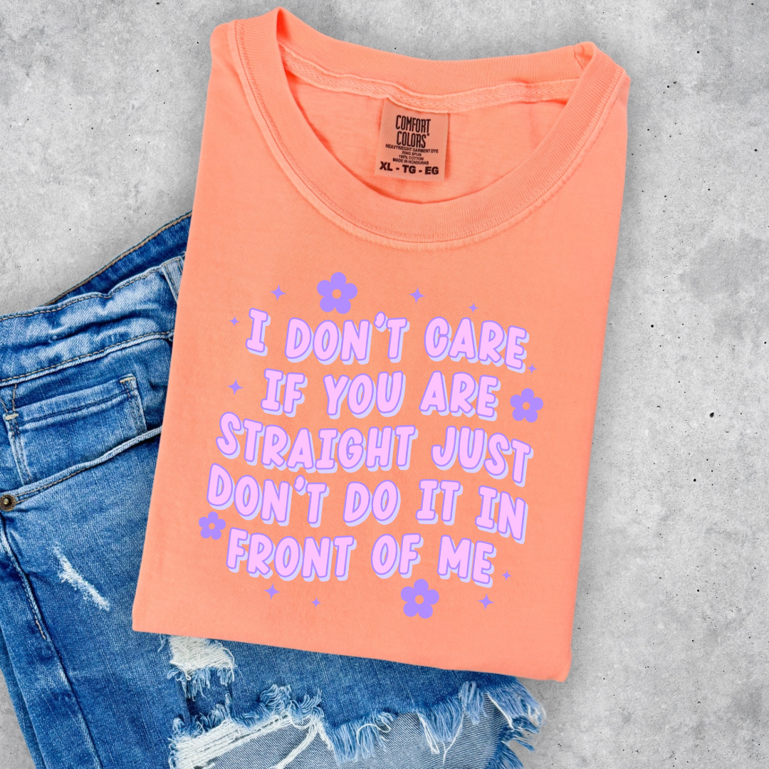 Customized Adult Comfort Colors Neon Cantaloupe  Graphic Tee Quoted " I don't care if you're straight just don't do it in front of me.  Purple bubble letters with flowers spread out Matching Adult Crewnecks available Perfect for Pride.