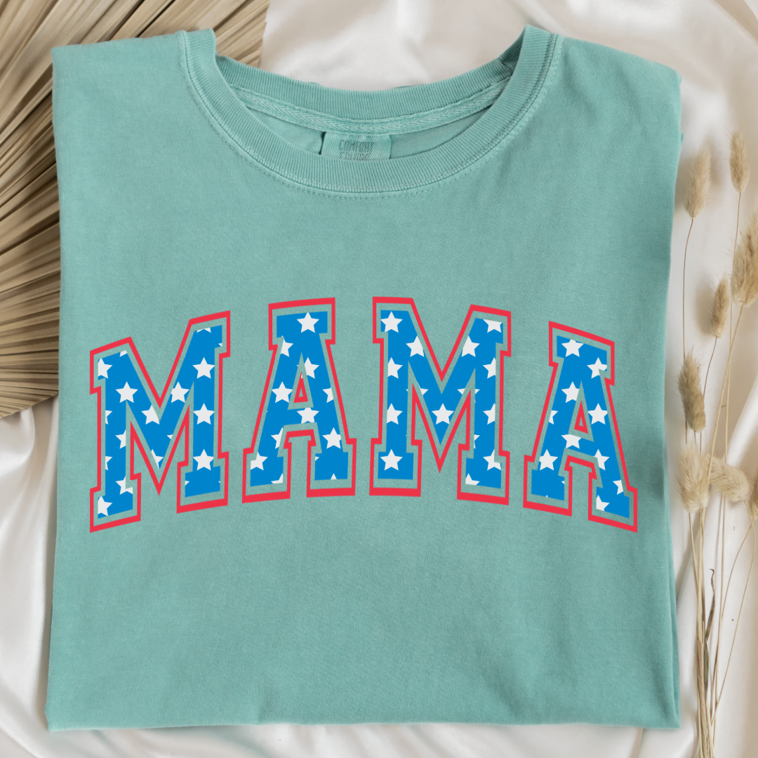 Customized adult Comfort Colors Chalky Mint Green Graphic Tee  with Seasonal 4th of July University style Font MAMA blue with white stars outlined un red , This style is available in adult  Graphic Tees as well as adult crewnecks and hoodies .Available In DAD, MAMA and MINI. 