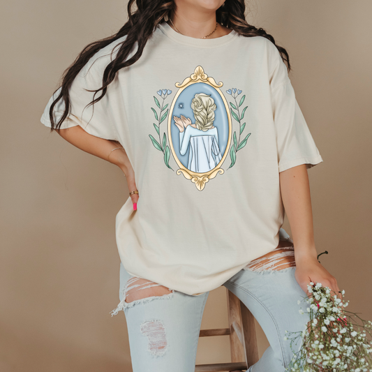 Customized comfort colors Ivory Graphic tee Disney Princess Elsa back silhouette in a gold mirror with flower vines up the side. Designs are available in Adult and youth graphic tees as well as youth and adult crewnecks and adult hoodies. 